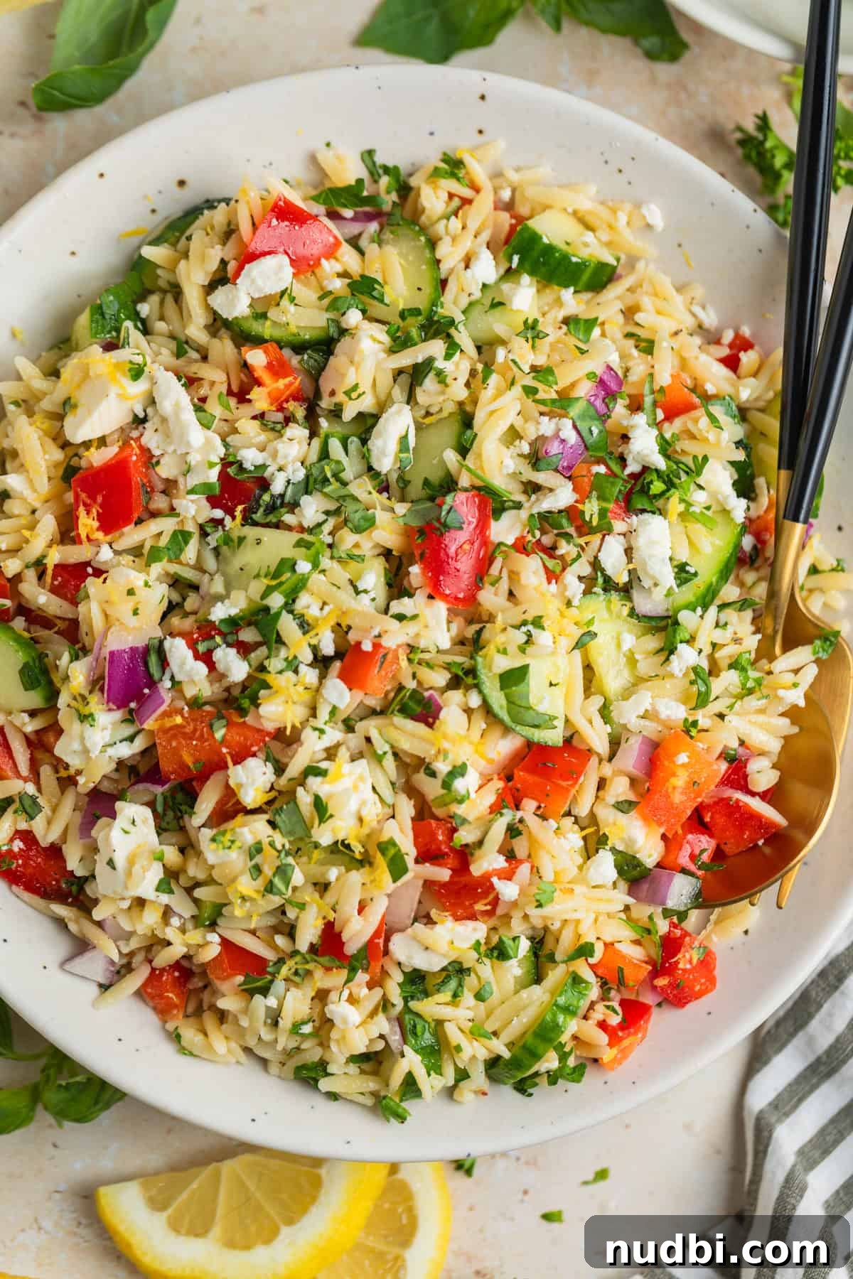 Lemon Orzo Salad with Feta, Herbs & Olive Oil Dressing 2 Overhead view of lemon orzo salad with fresh parsley and feta.