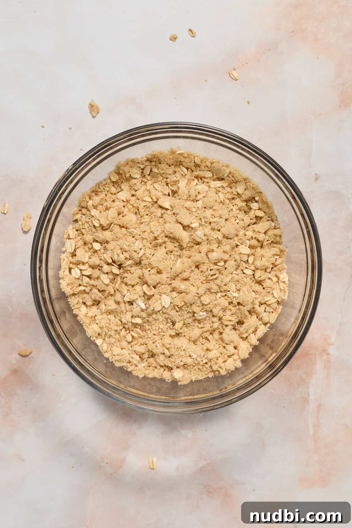 Strawberry Crumble Recipe with Buttery Oat Topping 7 Oat crumble mixture tossed together in bowl.