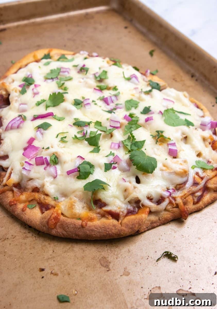 BBQ Ranch Chicken Flatbread Recipe — Crispy, Flavor-Packed Meal 5 BBQ chicken flatbread on pan with fresh cilantro.