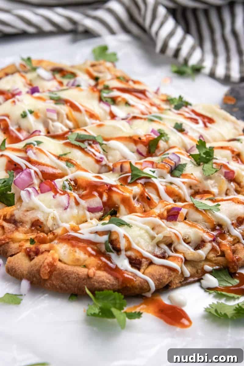 BBQ Ranch Chicken Flatbread Recipe — Crispy, Flavor-Packed Meal 6 BBQ chicken flatbread on wax paper sliced with ranch and BBQ sauce drizzle.