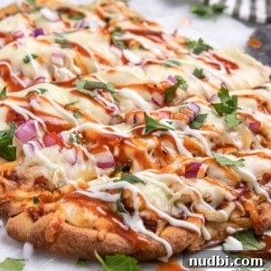 BBQ Ranch Chicken Flatbread Recipe — Crispy, Flavor-Packed Meal 7 BBQ chicken flatbread with ranch and bbq sauce drizzle and fresh cilantro.