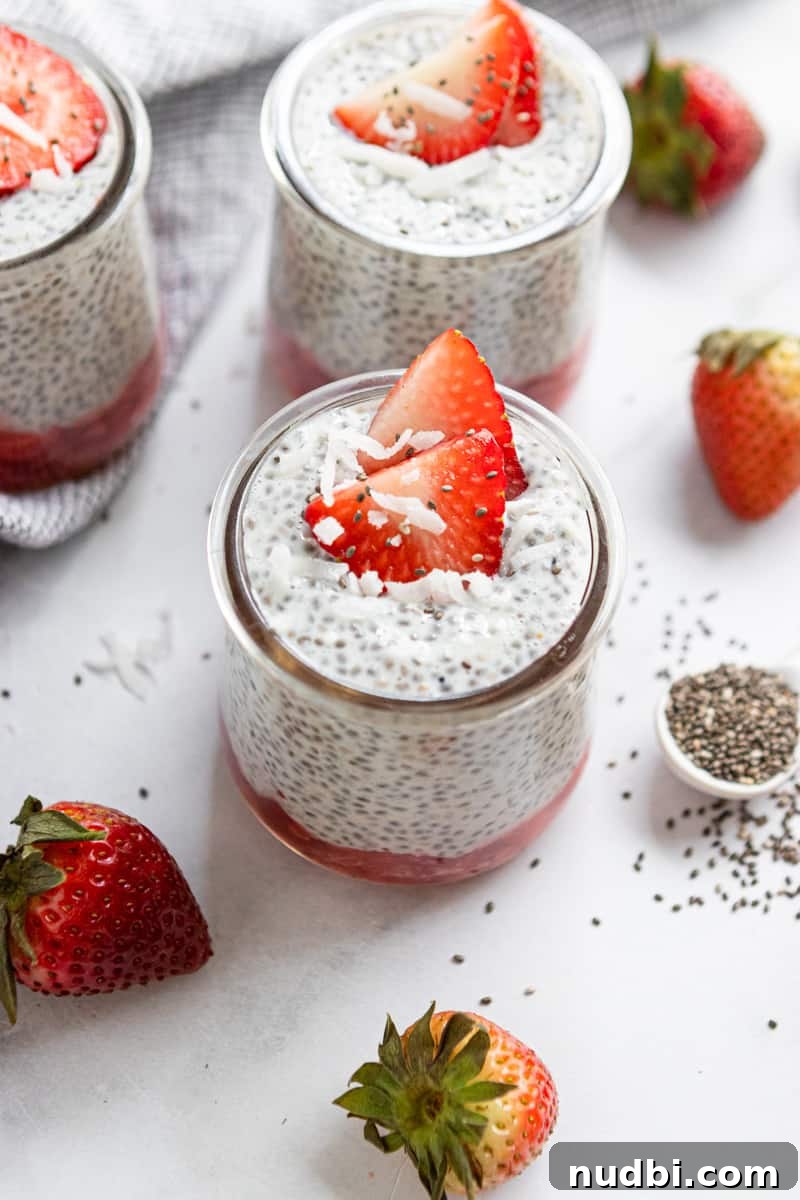 Coconut Vanilla Chia Pudding with Fresh Strawberries 2 Chia pudding in a jar with coconut and strawberries on top.