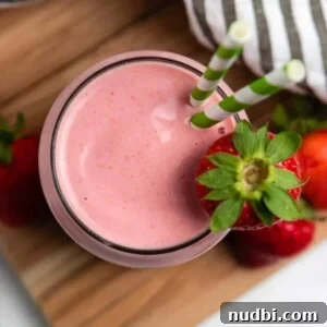 Strawberry Peanut Butter Smoothie Recipe for Creamy Protein Boost 6 Overhead view of strawberry peanut butter smoothie with green straws.