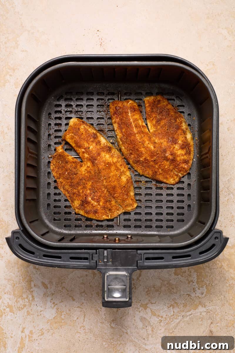 Crispy Air Fryer Fish Tacos with Cilantro-Lime Slaw 6 Tilapia in air fryer after cooking.