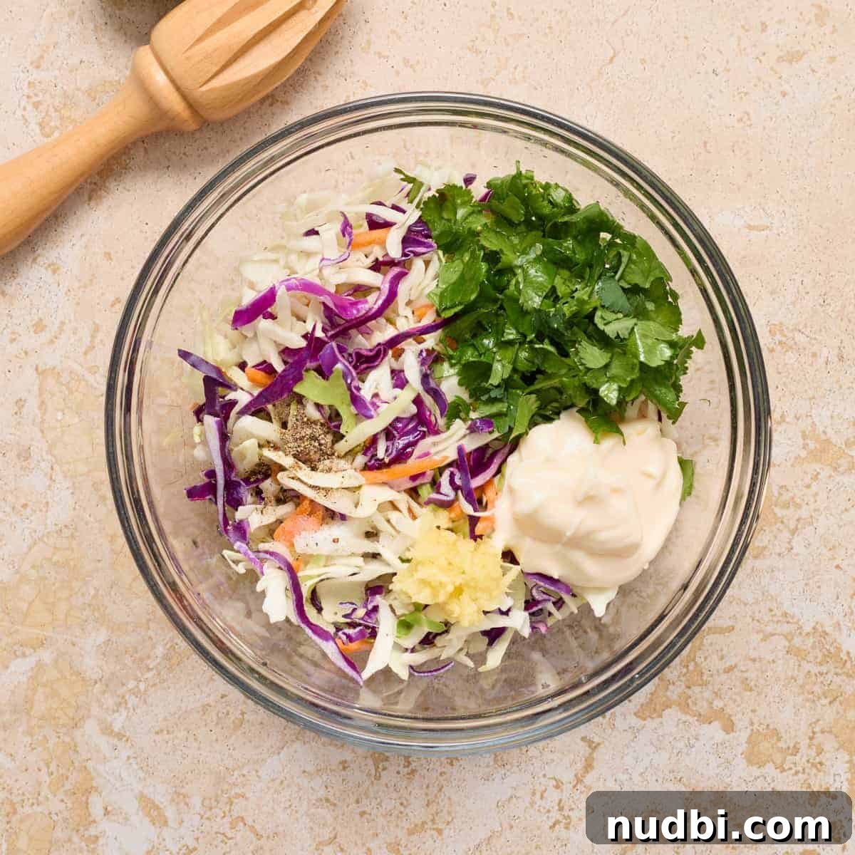 Crispy Air Fryer Fish Tacos with Cilantro-Lime Slaw 7 Cilantro lime slaw ingredients in glass mixing bowl.