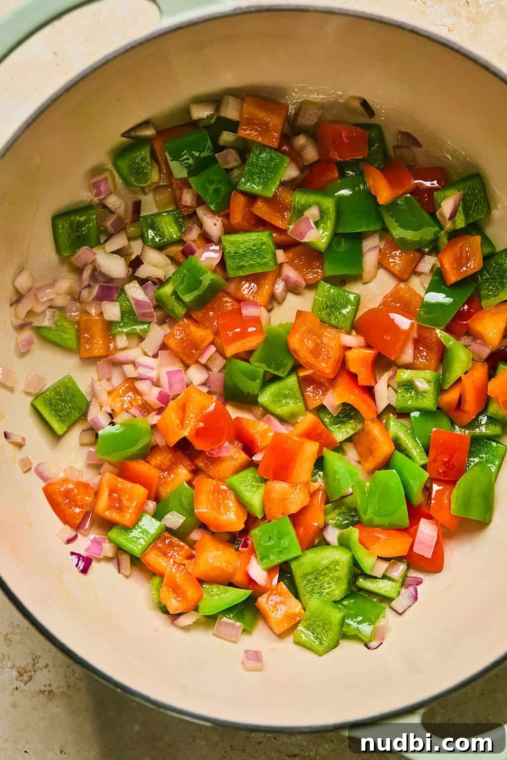 Hearty Butternut Squash Chili Recipe for Cozy Weeknights 5 Sautéed onions and pepper in pot.