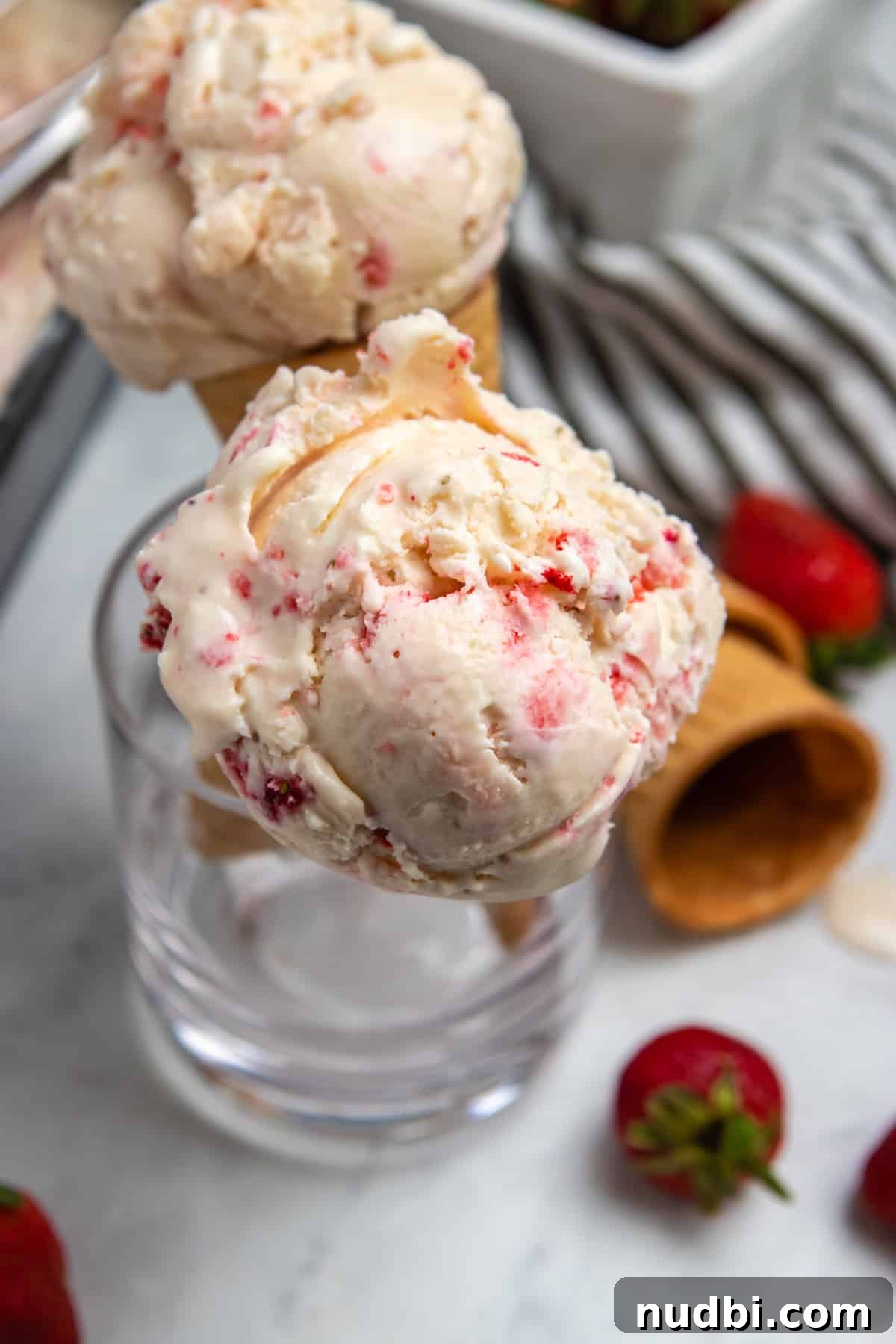 Creamy No-Churn Strawberry Ice Cream Recipe 7 Ice cream cones held up in glass cup.