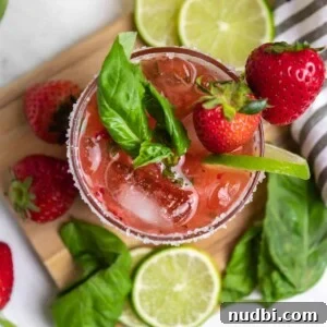 Strawberry Basil Margarita Recipe: Fresh, Tangy Cocktail Guide 9 Overhead view of strawberry basil margarita with fresh lime and berries.