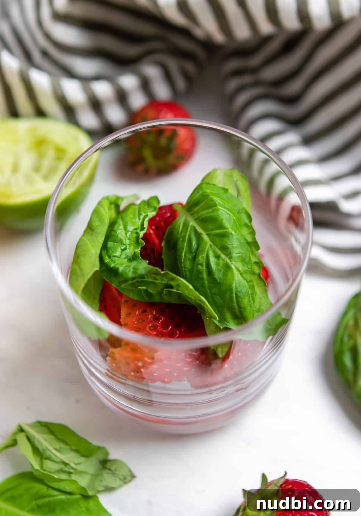 Strawberry Basil Margarita Recipe: Fresh, Tangy Cocktail Guide 4 Strawberries and basil in glass before muddling.