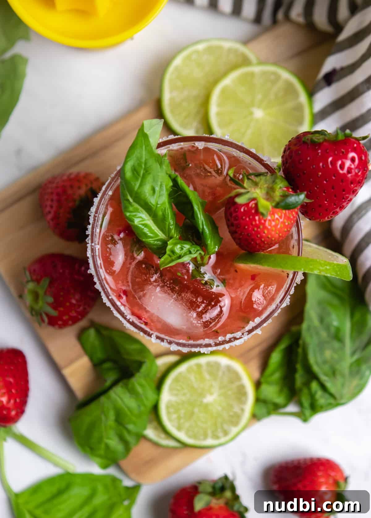 Strawberry Basil Margarita Recipe: Fresh, Tangy Cocktail Guide 7 Overhead view of glass with strawberry margarita with fresh basil leaves.