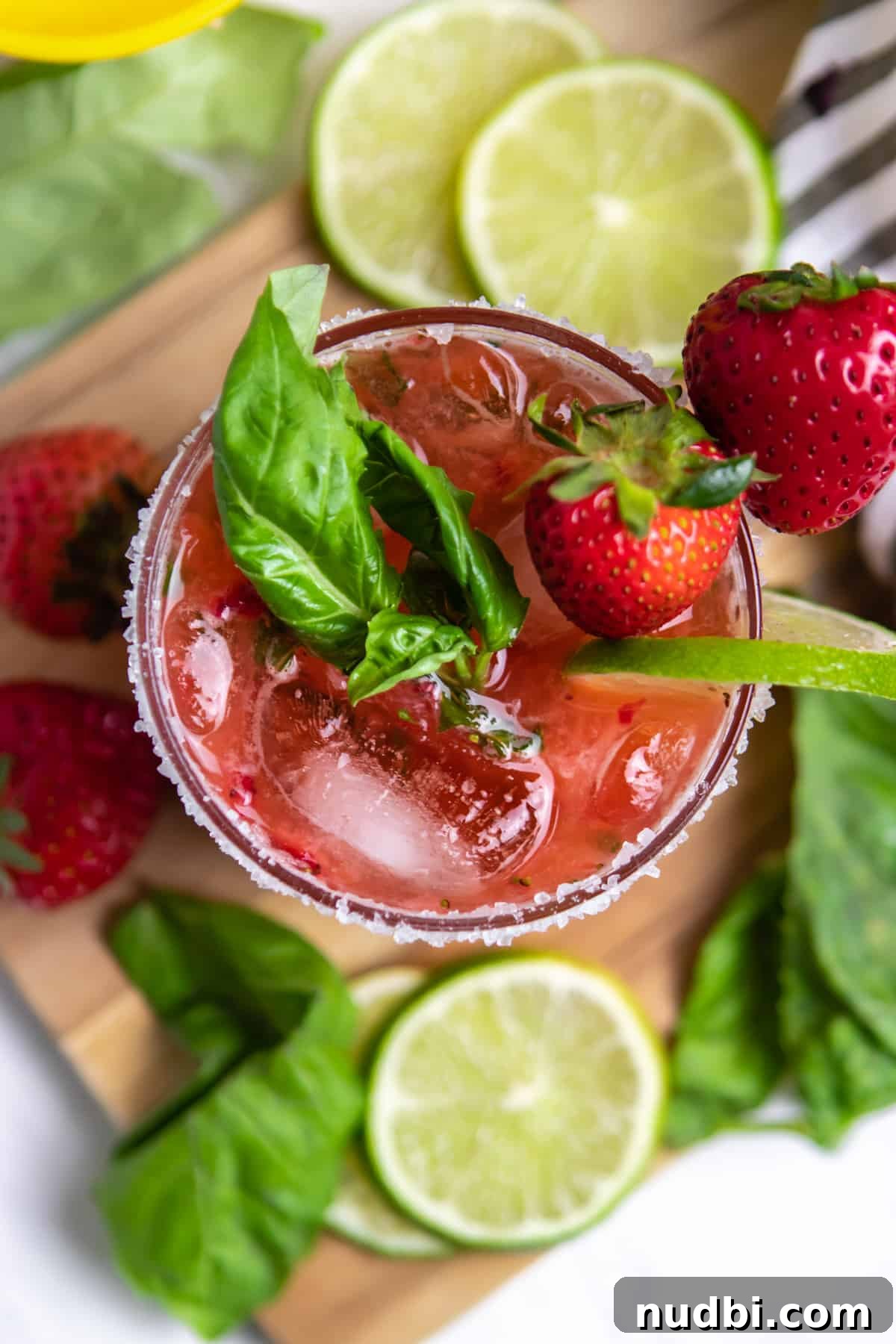 Strawberry Basil Margarita Recipe: Fresh, Tangy Cocktail Guide 8 Overhead view of strawberry margarita with basil, lime and strawberry garnish.