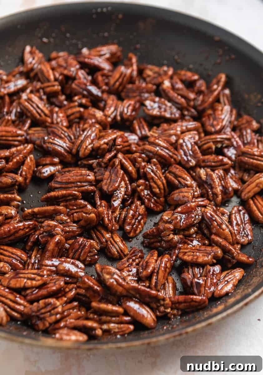 Maple-Glazed Candied Pecans Recipe for Holiday Snacking 6 Cooked candied pecans in nonstick skillet.