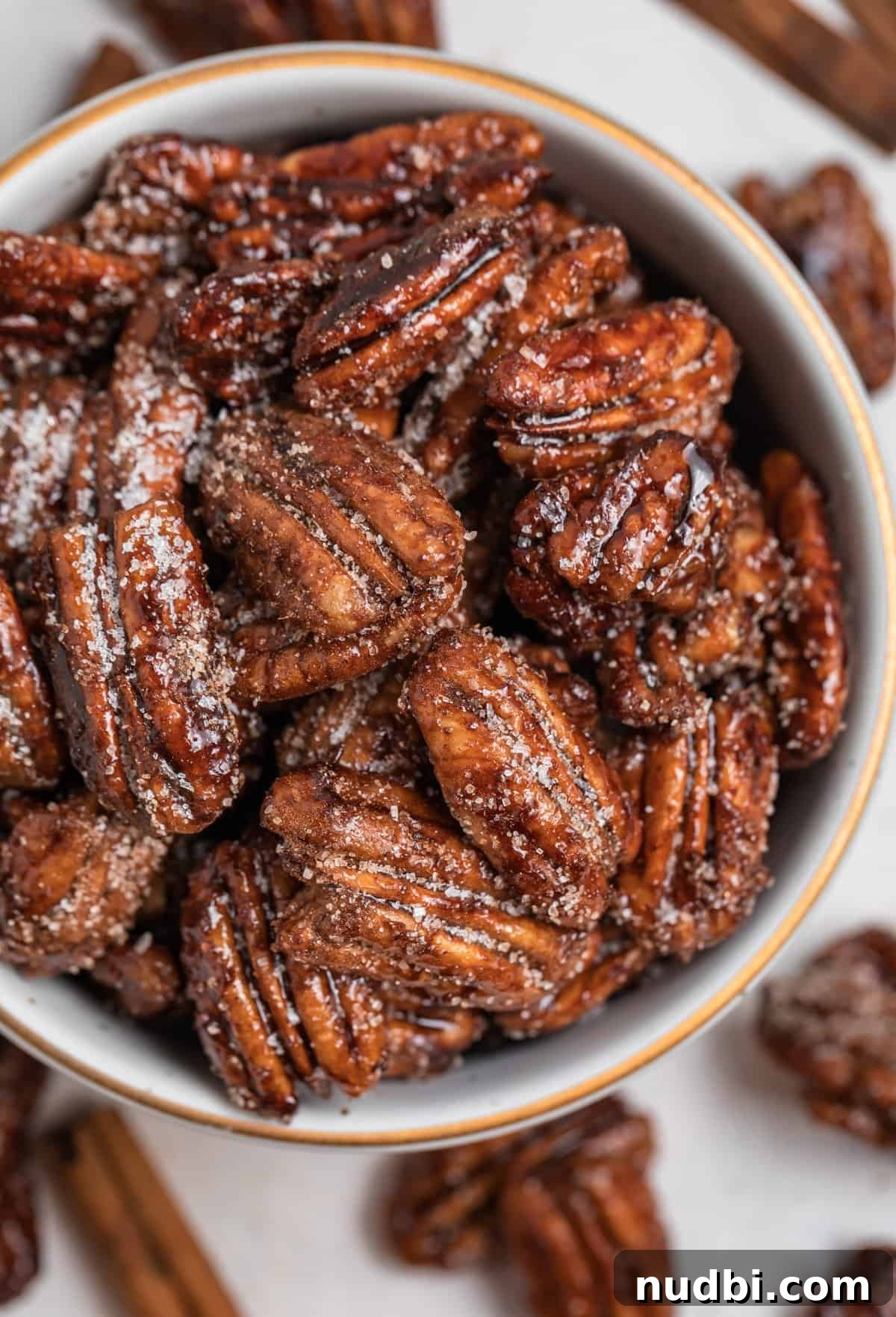 Maple-Glazed Candied Pecans Recipe for Holiday Snacking 8 Overhead view of bowl holding candied pecans.