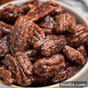 Maple-Glazed Candied Pecans Recipe for Holiday Snacking 9 Sugar dusted maple pecans in bowl.