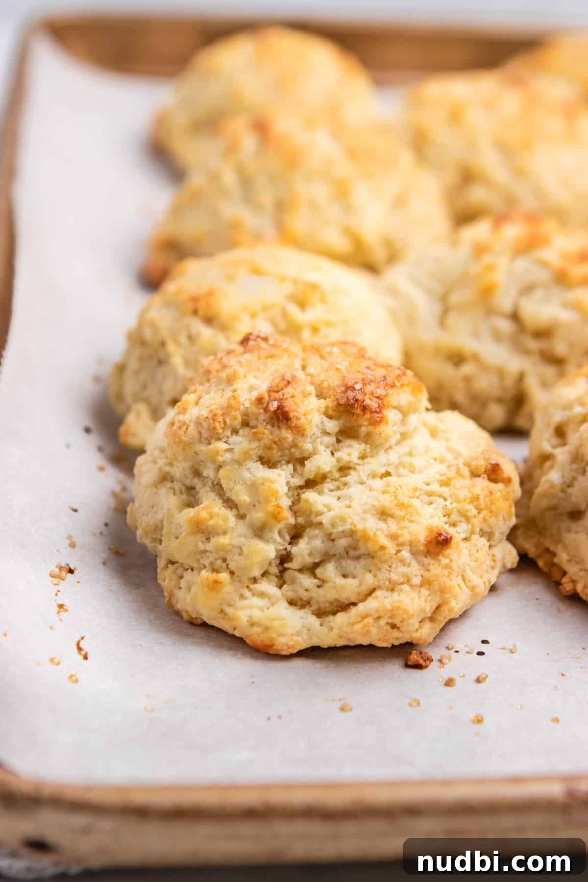 Strawberry and Peach Shortcake Recipe | Summer Dessert Guide 13 Buttermilk drop biscuits baked on parchment on sheet pan.