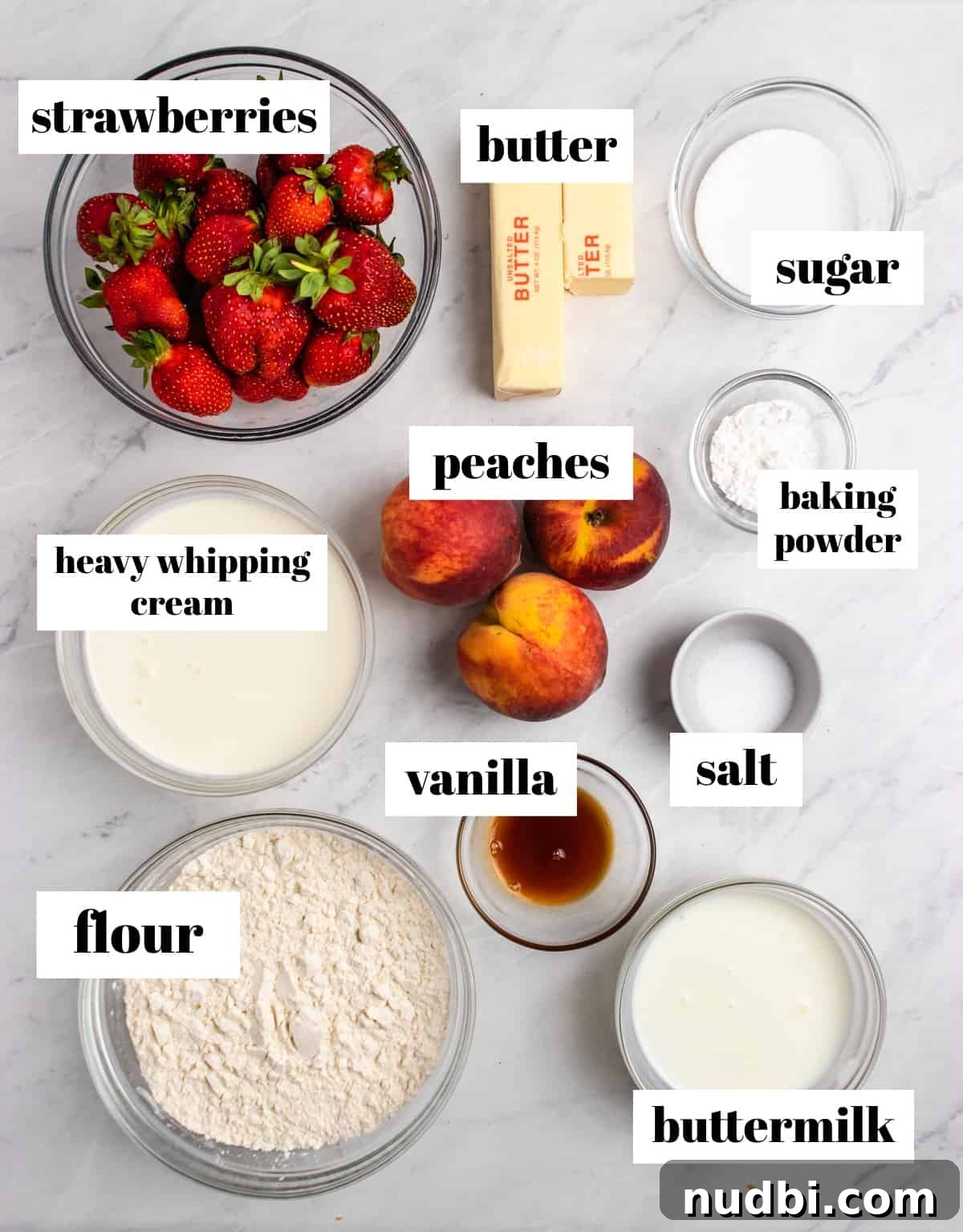 Strawberry and Peach Shortcake Recipe | Summer Dessert Guide 3 Flour, whipping cream, fruit, salt and other ingredients labeled on counter.