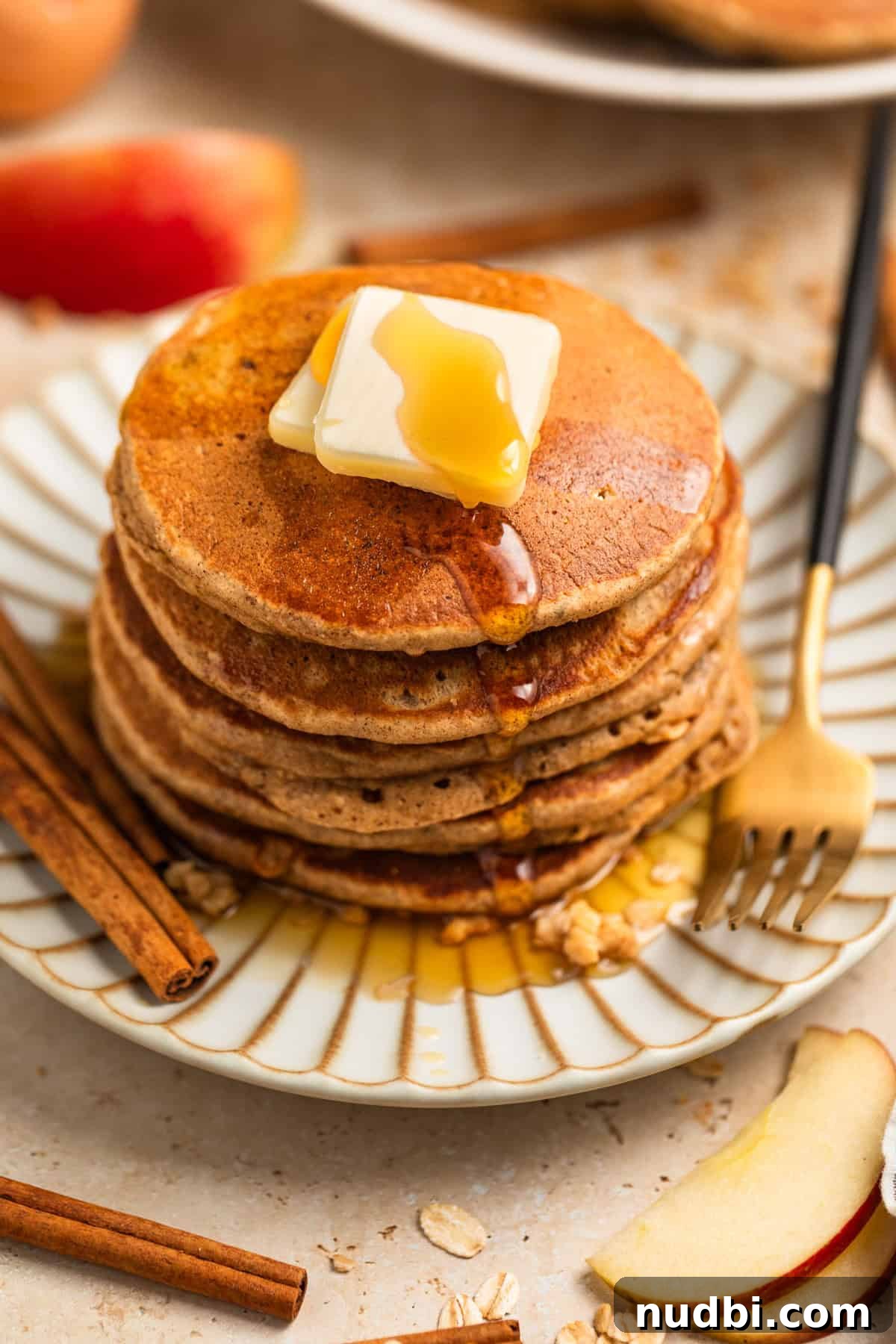 Apple Cinnamon Oatmeal Pancakes Recipe: Fluffy, Whole-Grain Breakfast 2 Stack of apple oatmeal pancakes on plate topped with butter and syrup.
