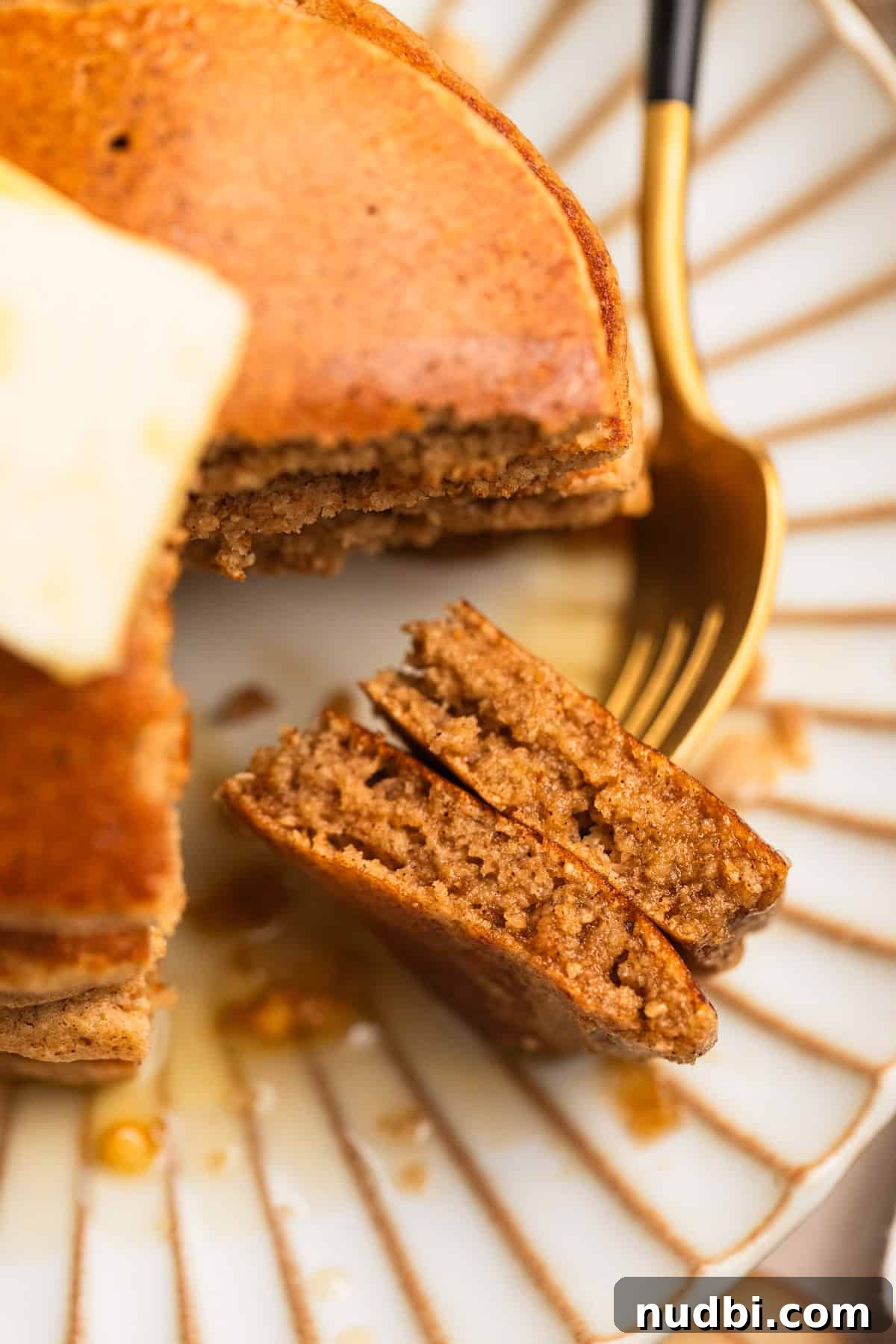 Apple Cinnamon Oatmeal Pancakes Recipe: Fluffy, Whole-Grain Breakfast 12 Fork with apple oat pancake pieces to show texture.