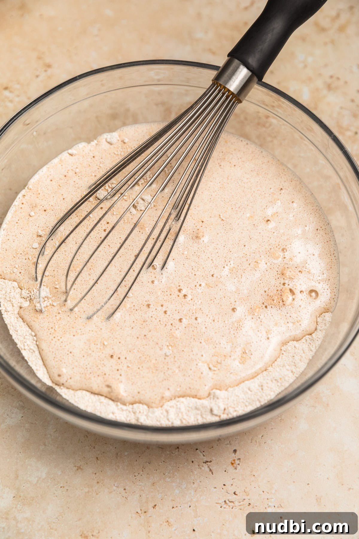 Apple Cinnamon Oatmeal Pancakes Recipe: Fluffy, Whole-Grain Breakfast 9 Wet and dry ingredients added to mixing bowl with whisk.