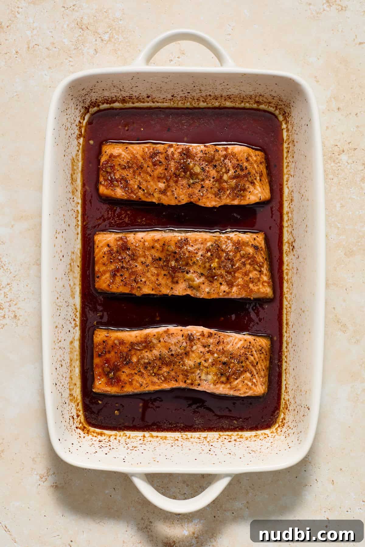 Maple Citrus Glazed Salmon with Tangy Orange Lemon Sauce 7 Baked citrus glazed salmon in baking pan.