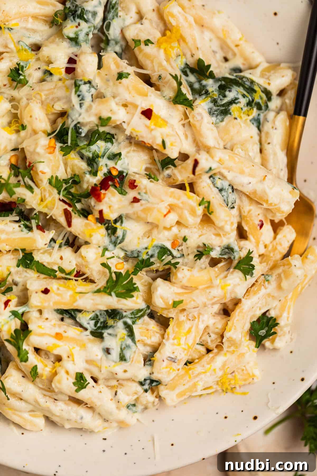 20-Minute Lemon Ricotta Pasta Recipe for Creamy Weeknight Meals 11 Plate with lemon ricotta creamy pasta topped with chopped parsley and grated parmesan.