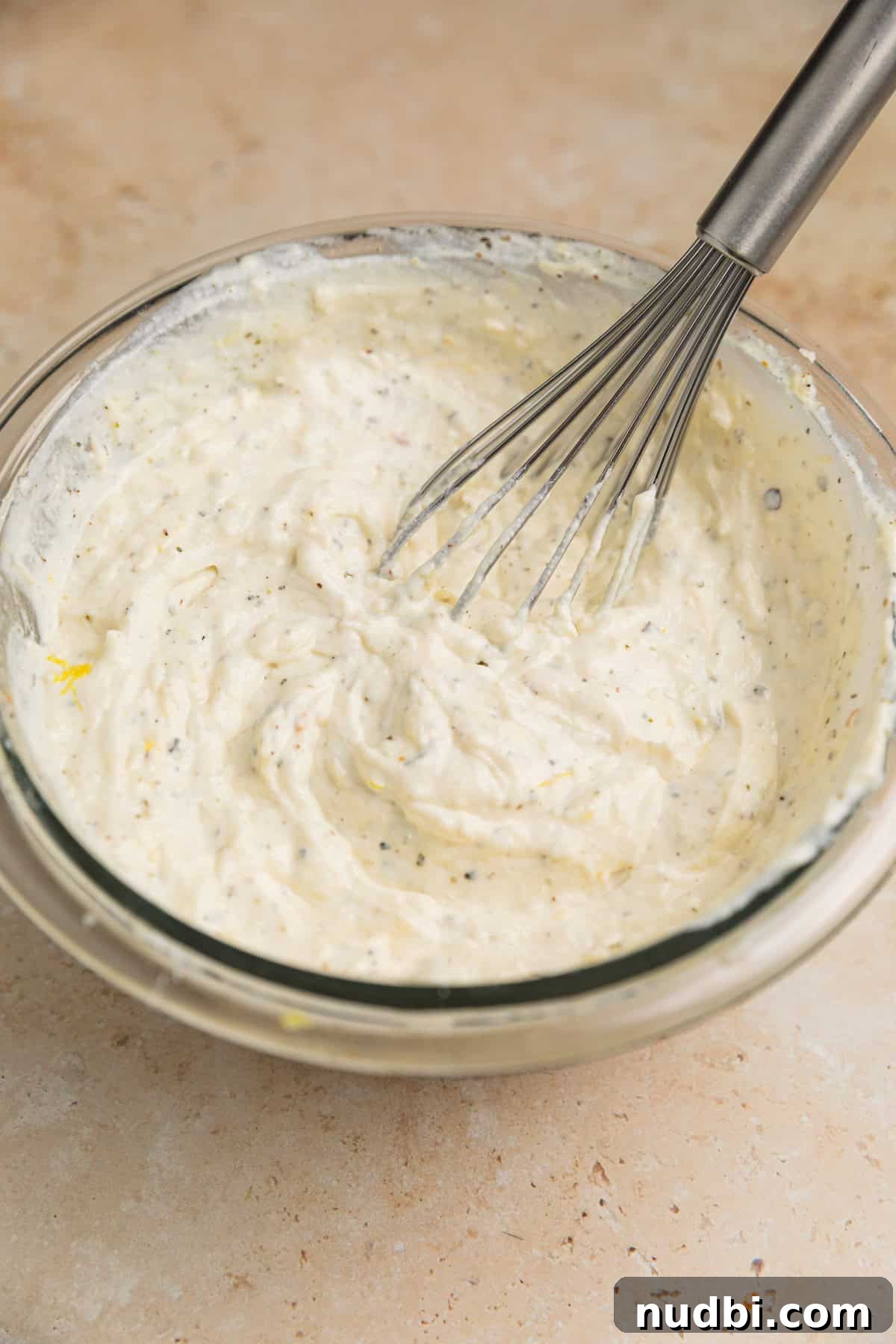 20-Minute Lemon Ricotta Pasta Recipe for Creamy Weeknight Meals 6 Lemon ricotta mixture in bowl with whisk.