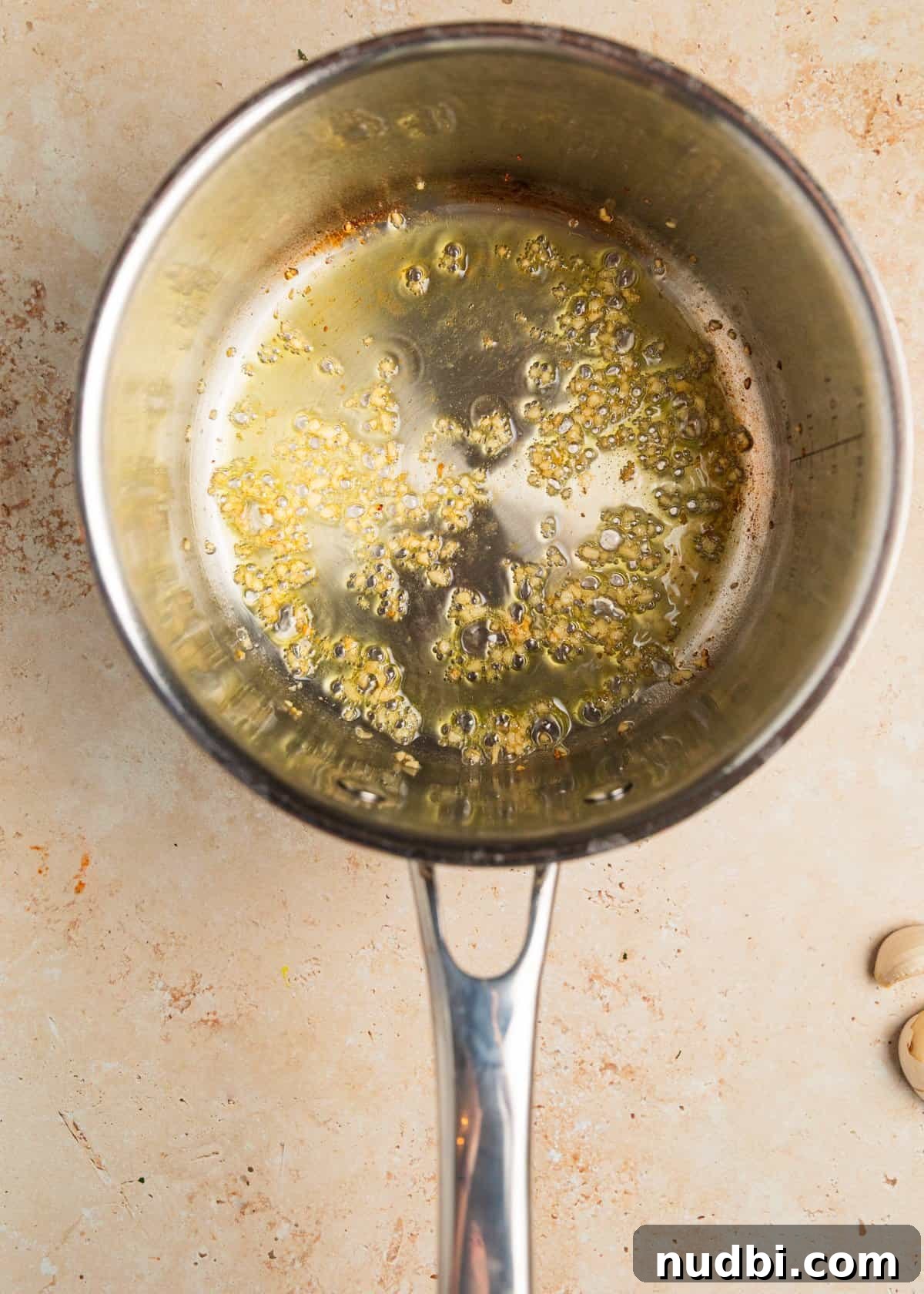 20-Minute Lemon Ricotta Pasta Recipe for Creamy Weeknight Meals 7 Garlic and olive oil in saucepan.