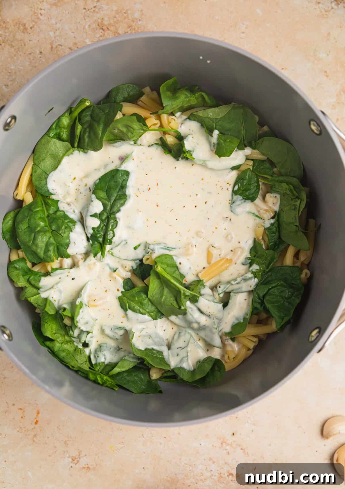 20-Minute Lemon Ricotta Pasta Recipe for Creamy Weeknight Meals 9 Pot with pasta and creamy ricotta sauce poured over with spinach.