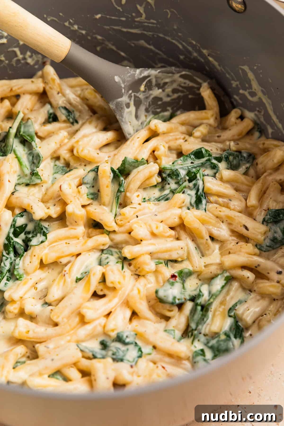 20-Minute Lemon Ricotta Pasta Recipe for Creamy Weeknight Meals 10 Lemon ricotta pasta in pot with spoon.
