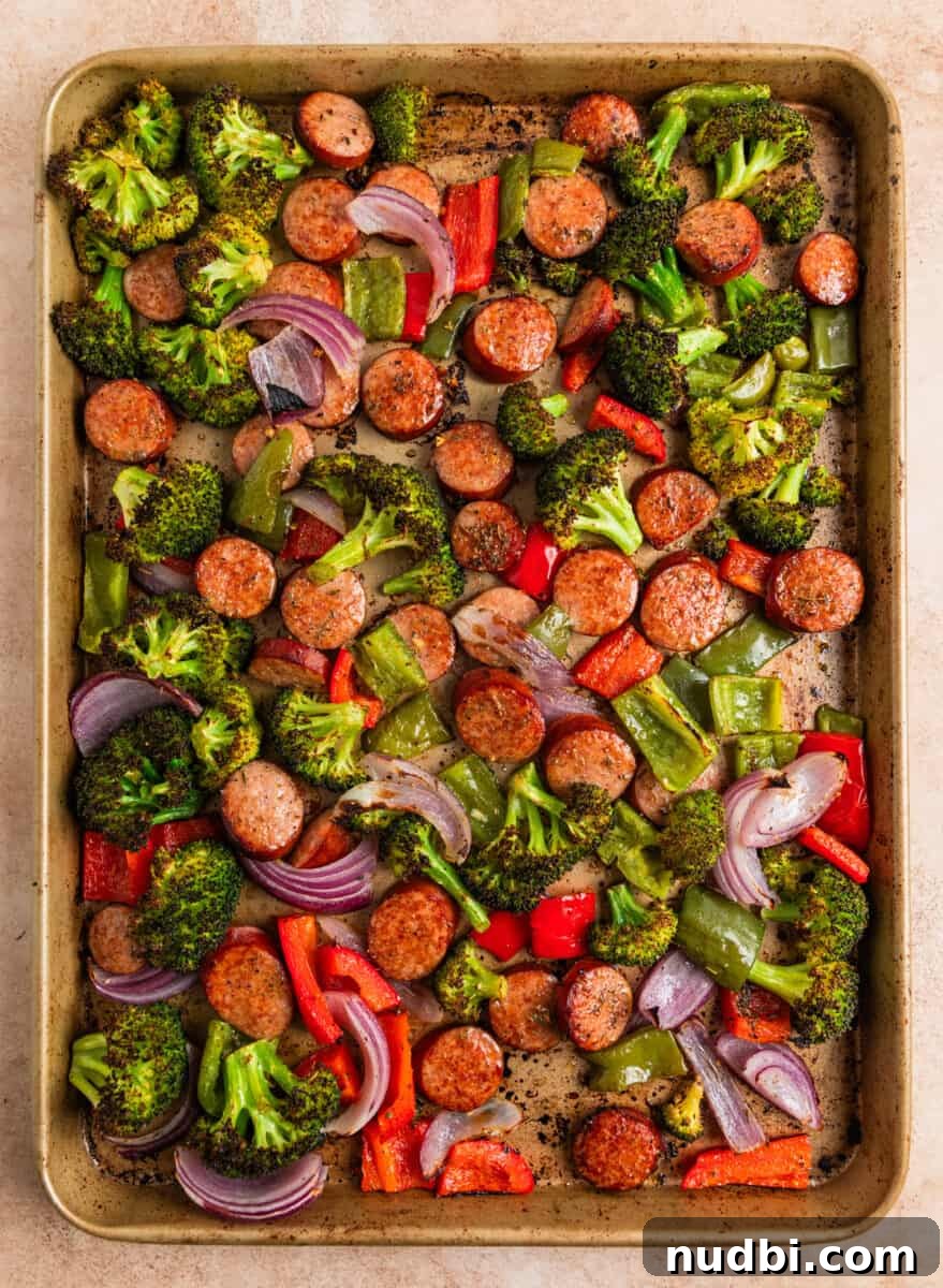 One-Pan Sausage and Veggie Sheet Pan Dinner 6 Cooked sausage and vegetable sheet pan dinner.