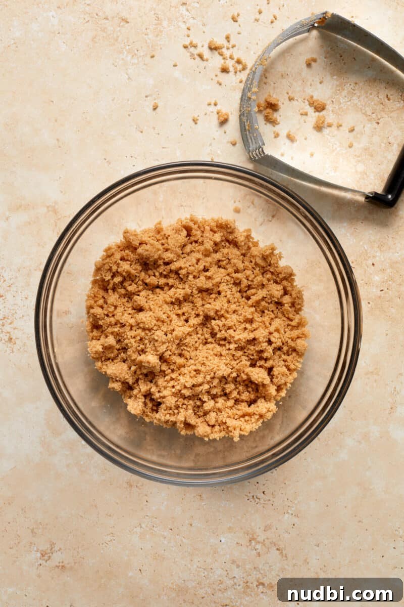 Cinnamon Streusel Pumpkin Coffee Cake Recipe for Fall Baking 11 Streusel topping in glass mixing bowl with pie cutter tool.