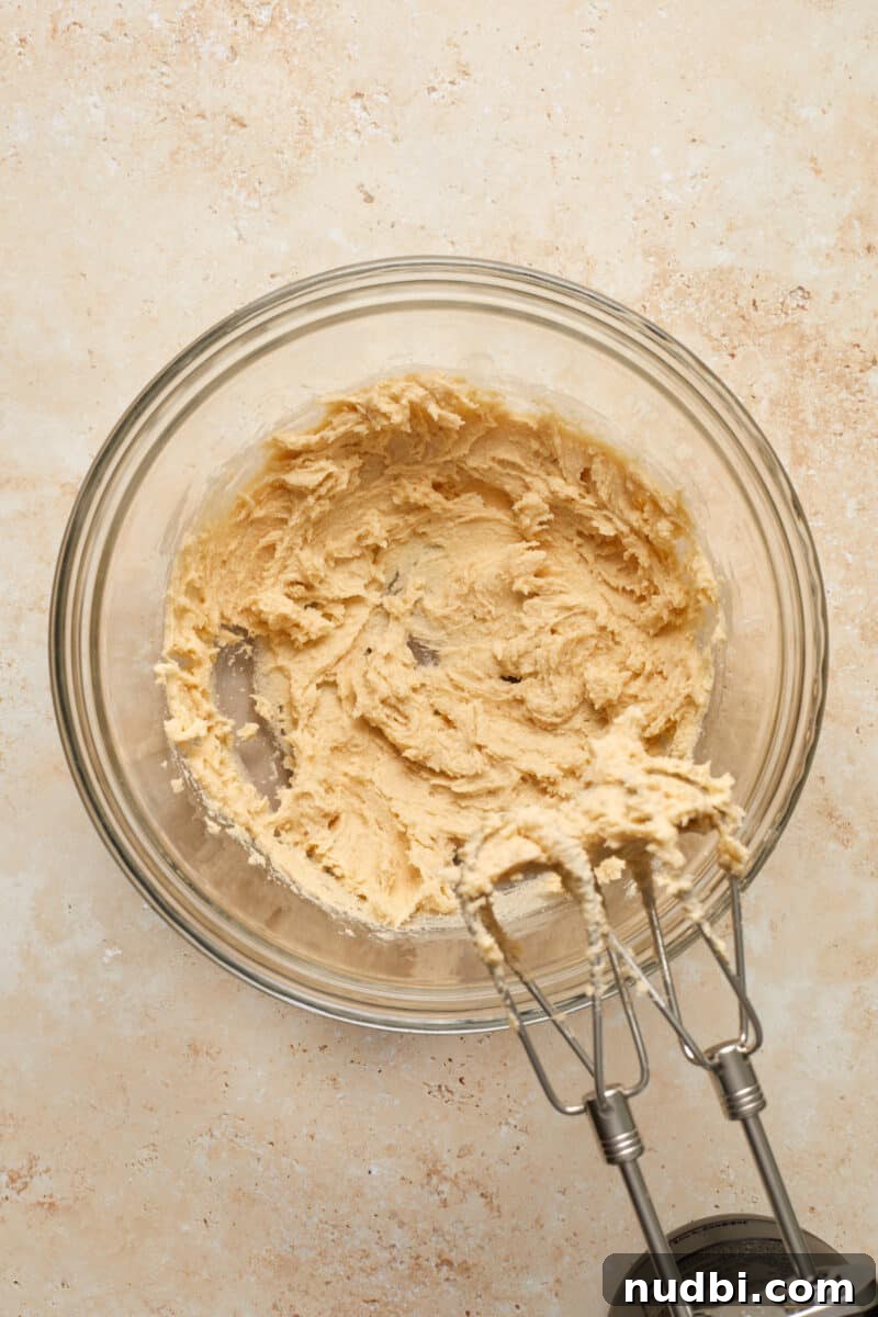 Cinnamon Streusel Pumpkin Coffee Cake Recipe for Fall Baking 7 Creamed butter and sugar in glass bowl with hand mixer.