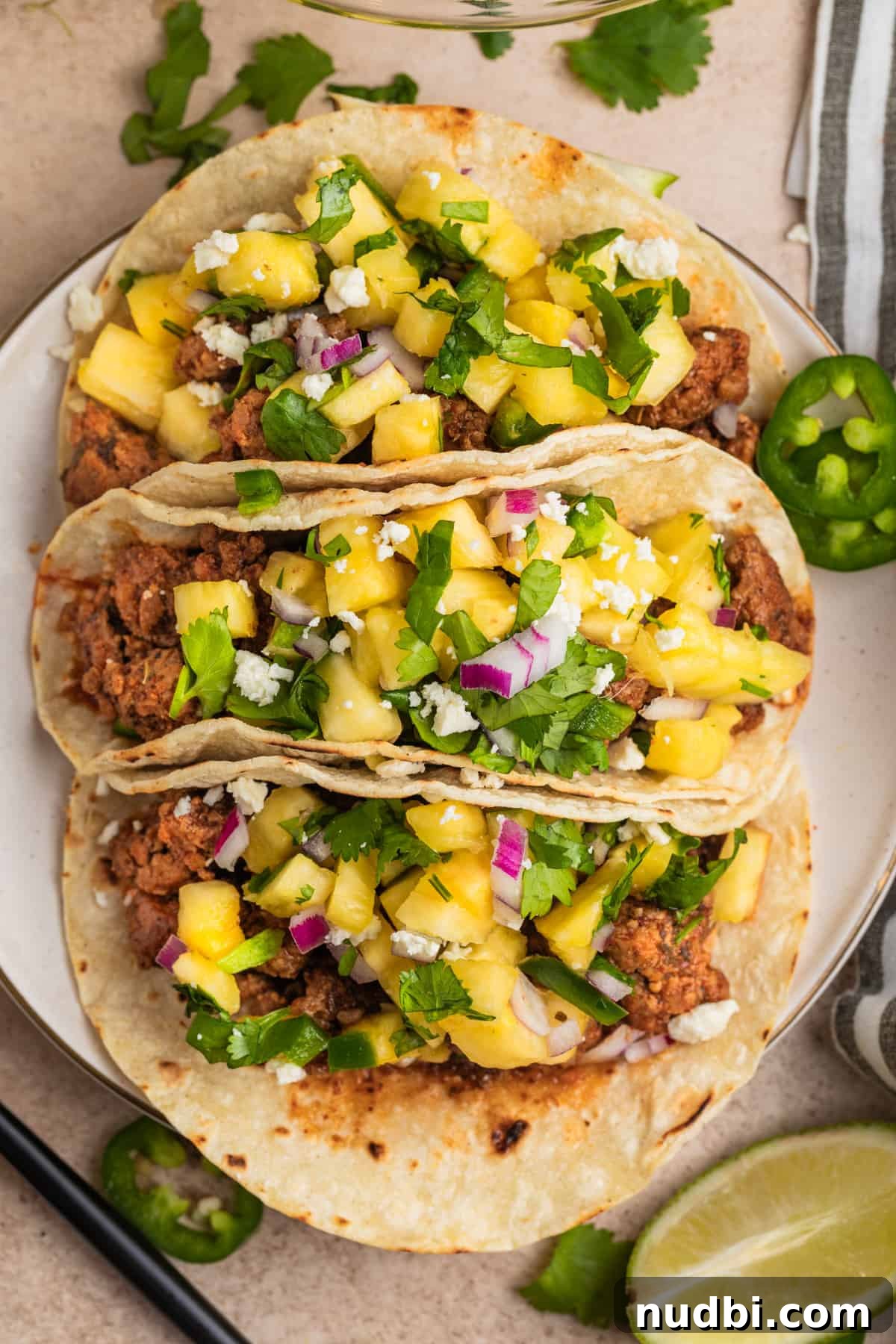 Pineapple Salsa Ground Pork Tacos: Sweet & Spicy Street-Style Recipe 2 Overhead view of ground pork tacos topped with pineapple salsa.
