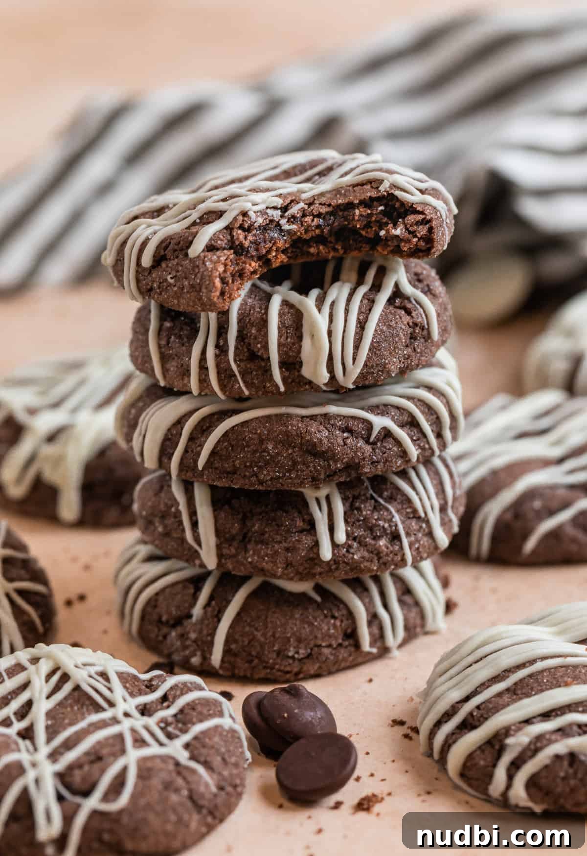 Chewy Chocolate Cake Mix Cookies Recipe for Perfect Cocoa Treats 3 Stack of chocolate cake mix cookies with other cookies and chocolate chips surrounding.