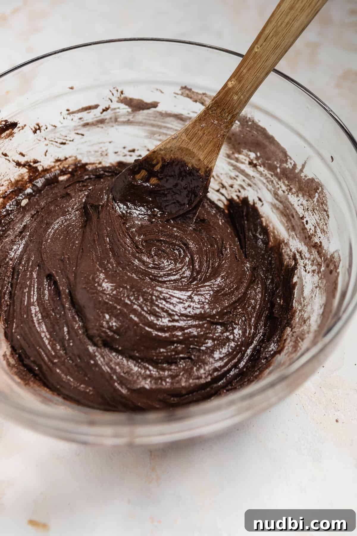 Chewy Chocolate Cake Mix Cookies Recipe for Perfect Cocoa Treats 5 Glass mixing bowl with chocolate cookie dough and wooden spoon.