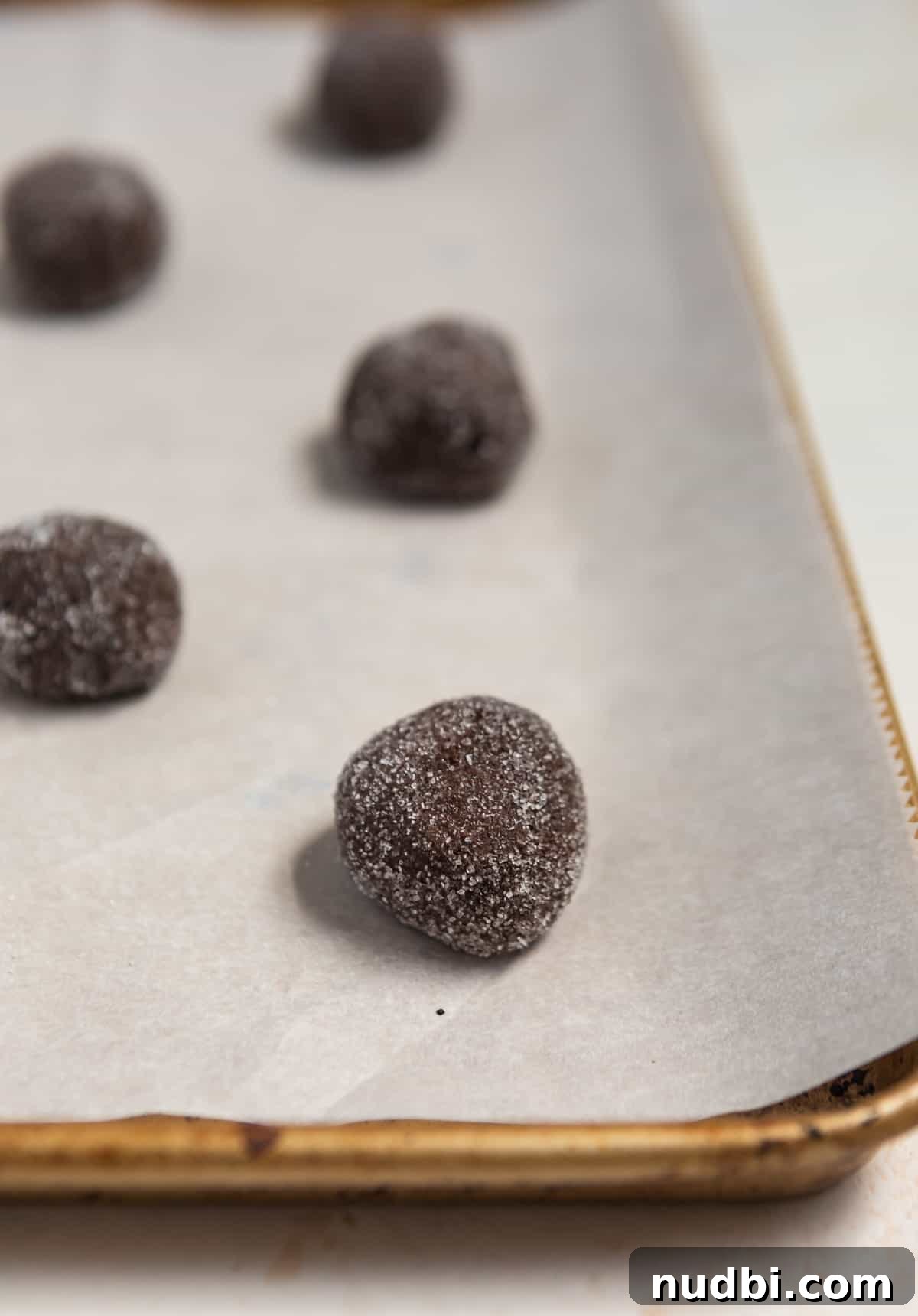 Chewy Chocolate Cake Mix Cookies Recipe for Perfect Cocoa Treats 6 Chocolate cookie dough balls on parchment lined baking sheet.