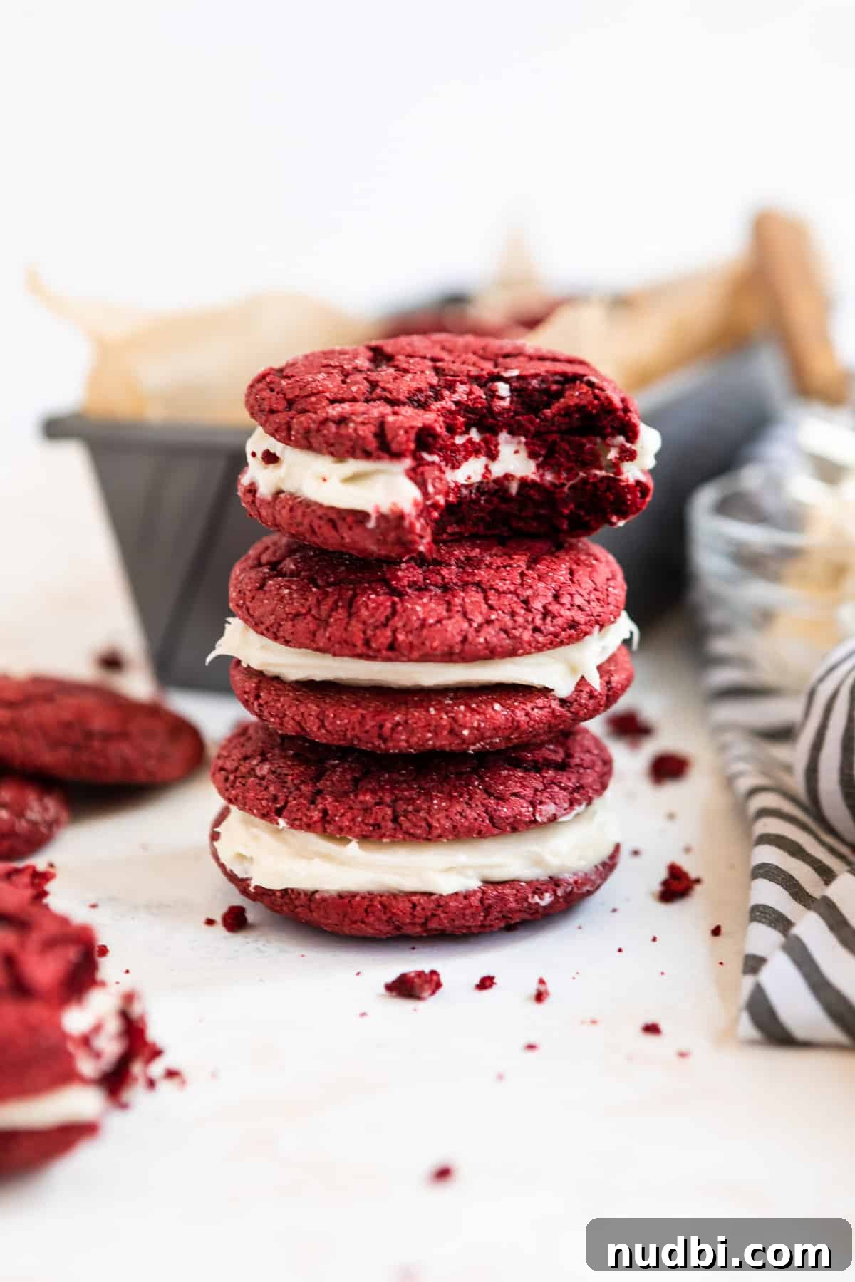 Red Velvet Cake Mix Cookies with Cream Cheese Frosting 2 Stack of red velvet cake mix cookies with cream cheese icing.