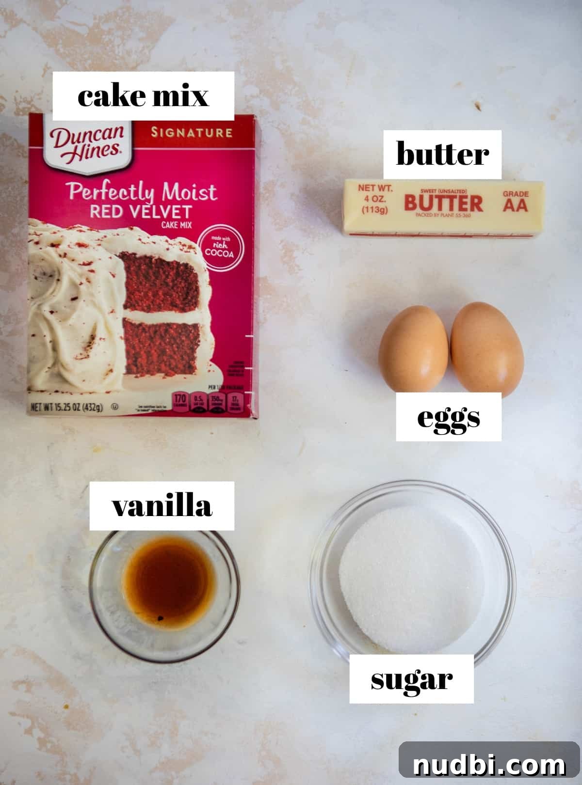 Red Velvet Cake Mix Cookies with Cream Cheese Frosting 3 Butter, cake mix, eggs and ingredients for cookies on counter labeled.