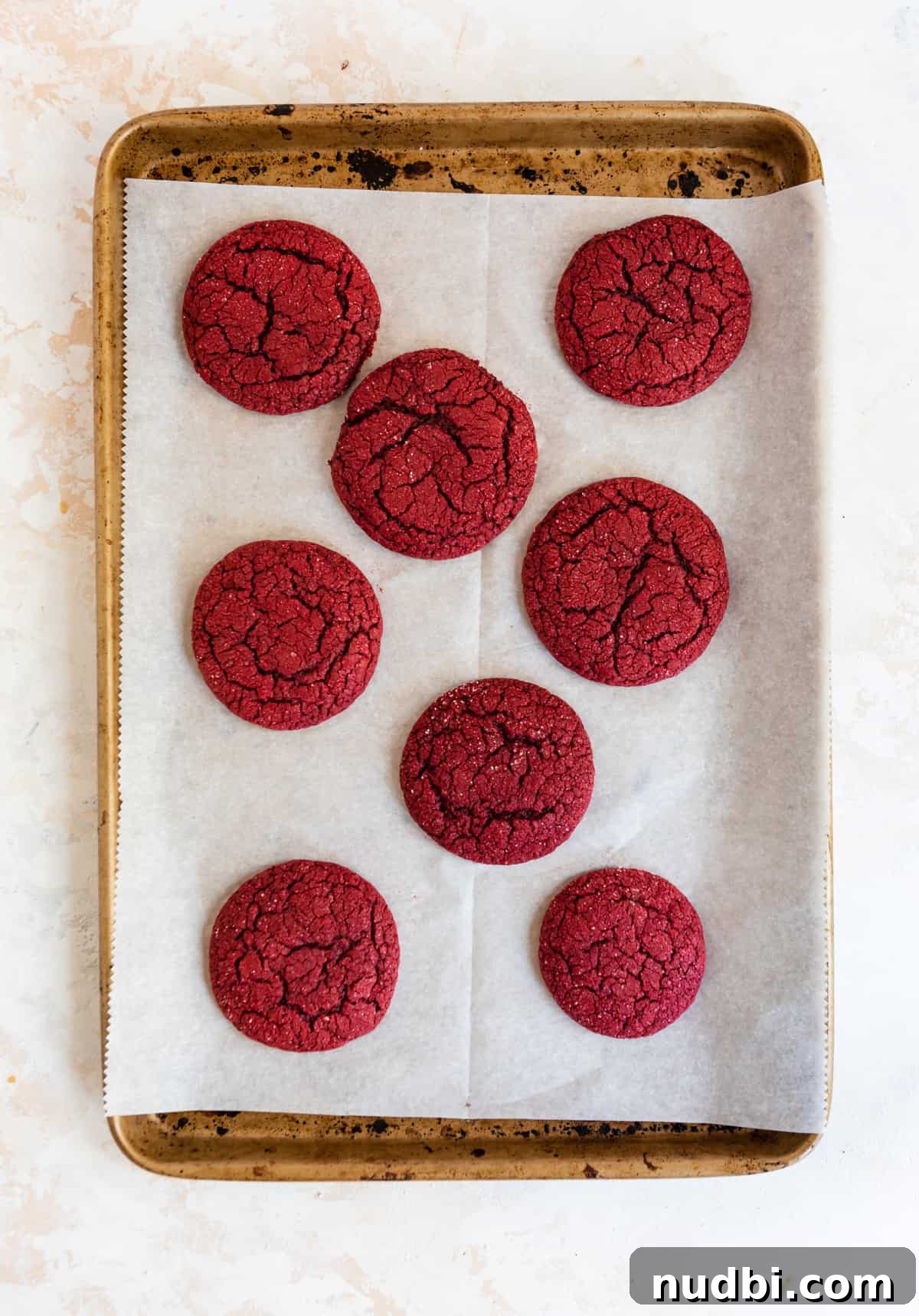 Red Velvet Cake Mix Cookies with Cream Cheese Frosting 5 Baked red velvet cake mix cookies on cookie sheet.