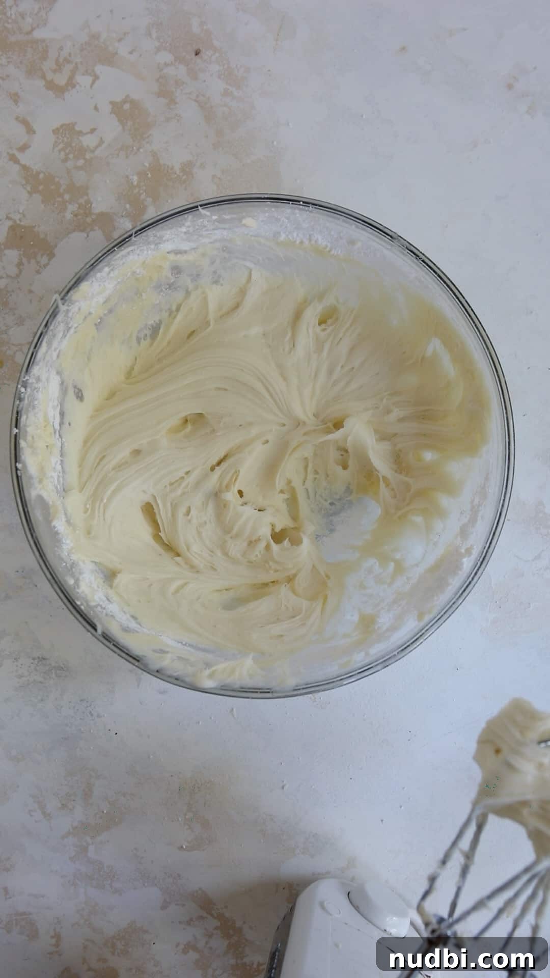 Red Velvet Cake Mix Cookies with Cream Cheese Frosting 6 Cream cheese icing in mixing bowl with electric mixer beside it.