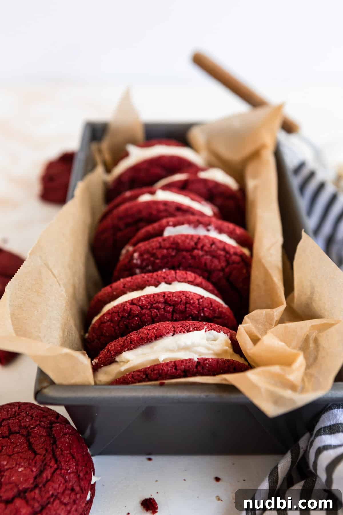 Red Velvet Cake Mix Cookies with Cream Cheese Frosting 8 Red velvet cake mix sandwich cookies in bread pan lined with parchment.