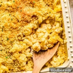 Creamy Cheddar and Gruyère Macaroni Bake 9 Macaroni and cheese in pan baked with breadcrumbs and chopped parsley on top.