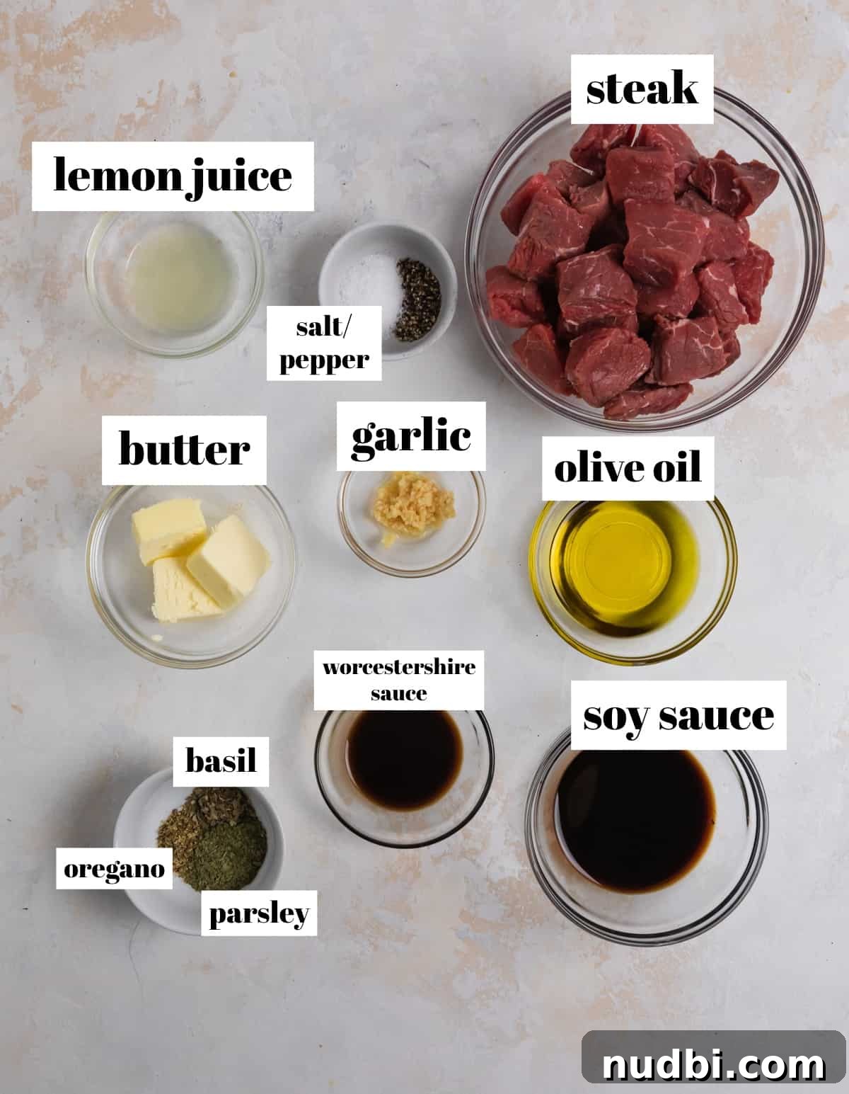 Crispy Air Fryer Steak Bites with Garlic Butter Dip 5 Olive oil, lemon juice, butter, herbs, and other ingredients labeled on counter.