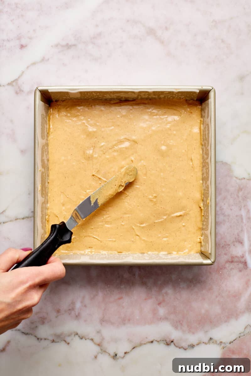 Quick Microwave Peanut Butter Fudge Recipe 8 Knife smoothing out fudge in pan.