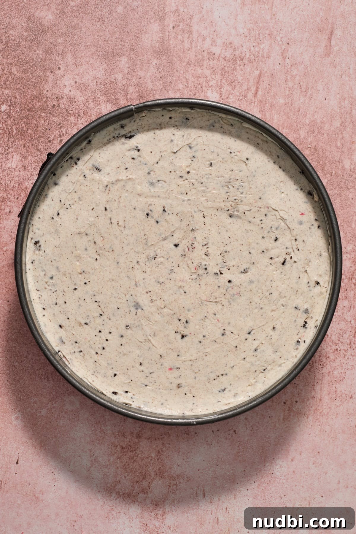 No‑Bake Peppermint Oreo Cheesecake Recipe for the Holidays 16 Prepared peppermint cheesecake with Oreo cookies in pan before chillling.