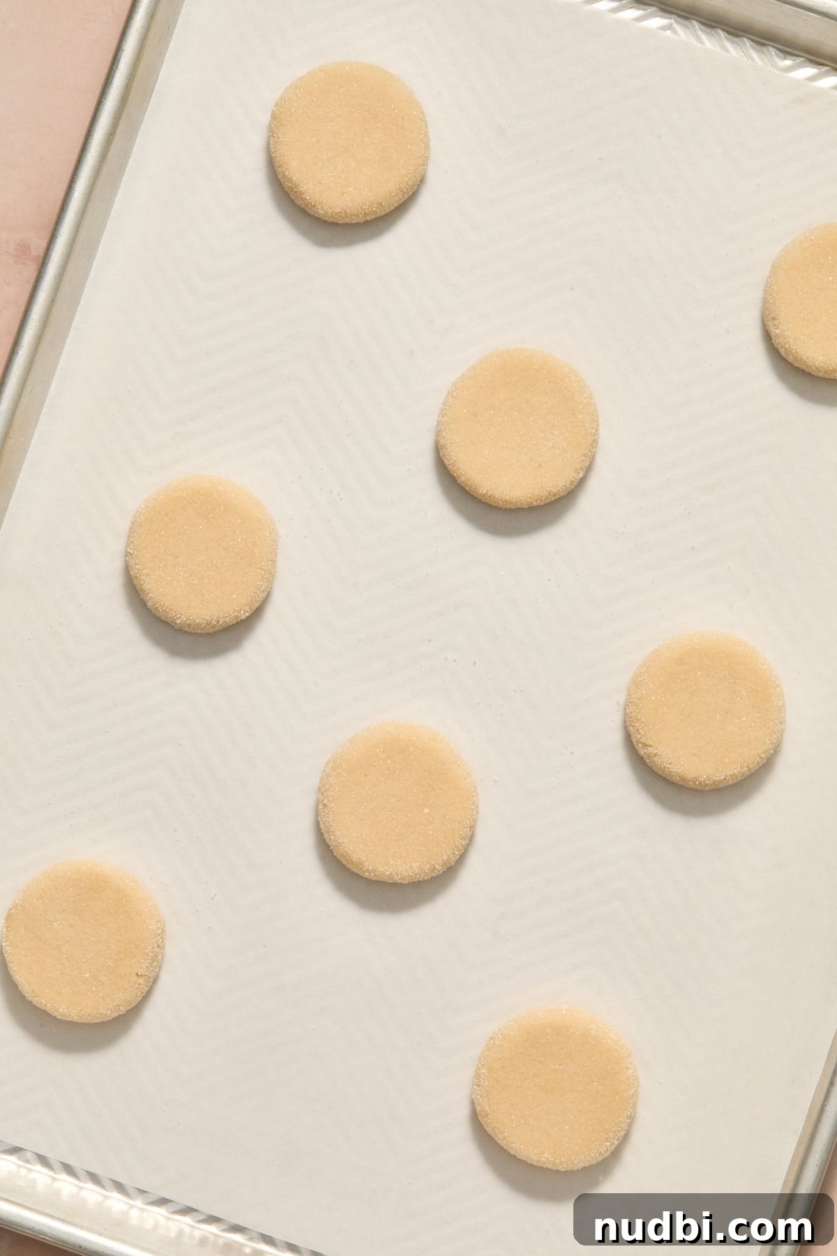 Soft and Chewy Eggless Sugar Cookies Recipe 8 Cookie dough pressed gently on pan with parchment.