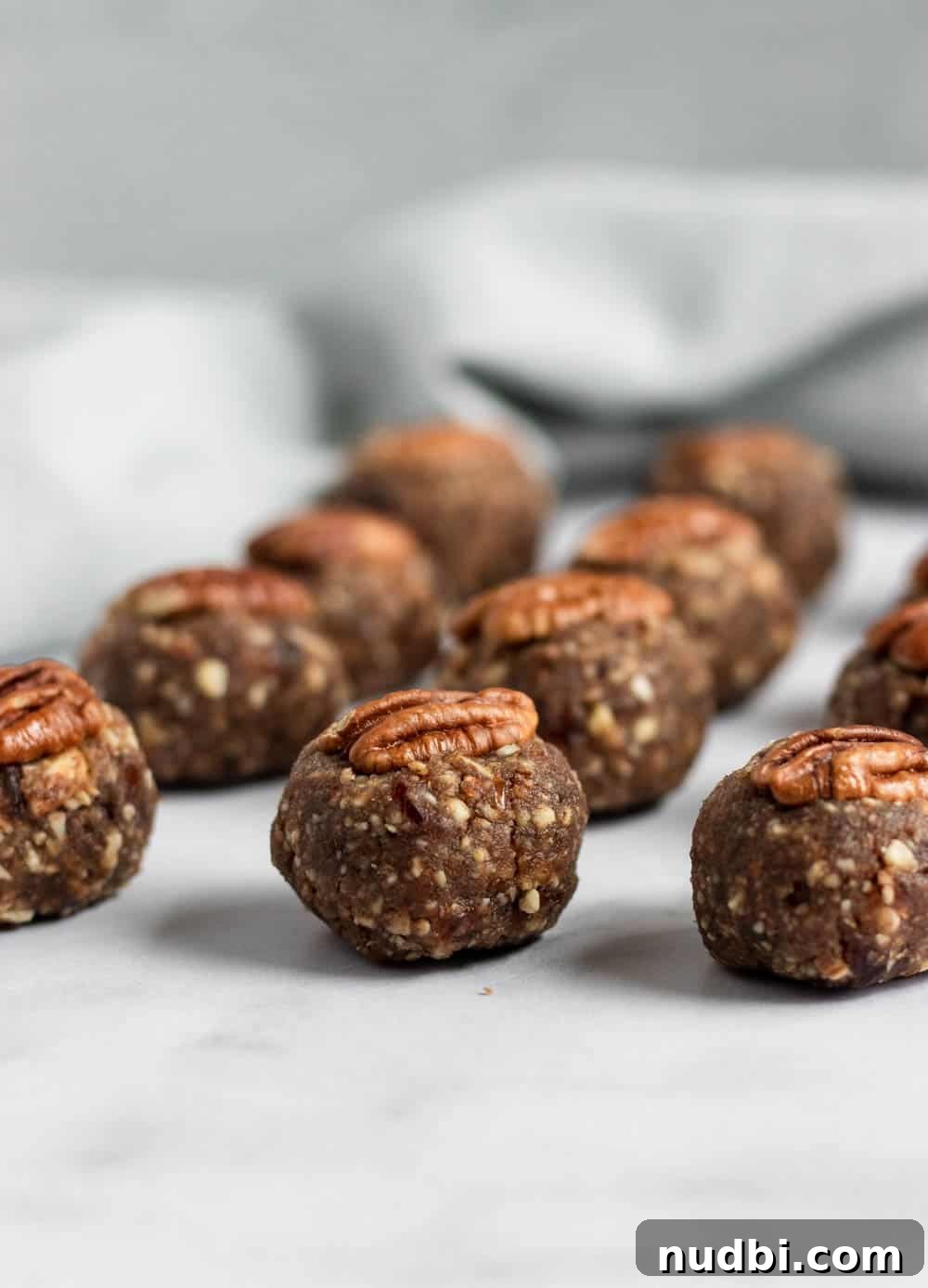Pecan Pie Energy Bites: No-Bake Snack for Lasting Energy 2 lined up pecan pie energy bites.