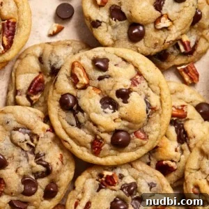Top Christmas Cookie Recipes to Bake This Holiday Season 12 Chocolate chip pecan cookies arranged on surface.