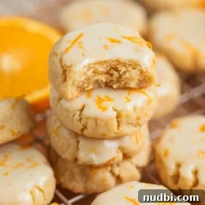 Top Christmas Cookie Recipes to Bake This Holiday Season 23 Stack of gluten free almond flour cookies with bite taken out of top cookie.