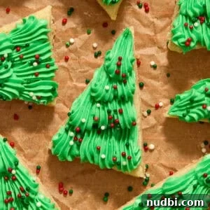 Top Christmas Cookie Recipes to Bake This Holiday Season 31 Frosted Christmas tree sugar cookie bars with red, green and white sprinkles.
